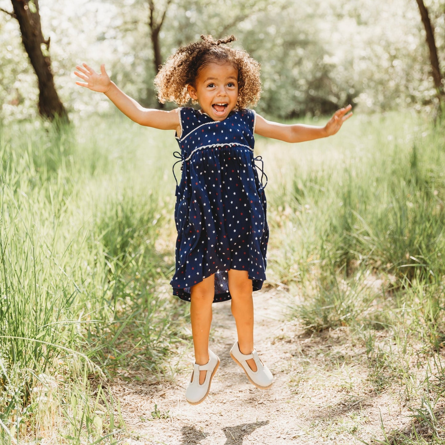A 3-year-old model showing the Blue Stars 4th of July Dress - LARILI