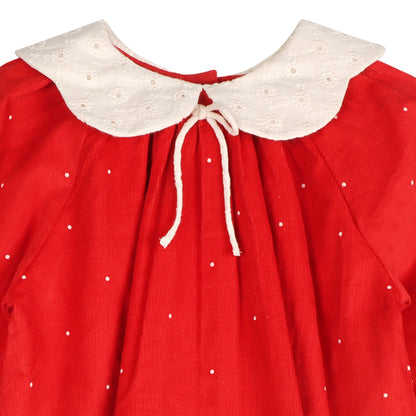 Flat lay Close up of the LARILI Christmas Carol Red Holiday Dress showing the tiny dot print, 100% cotton corduroy texture.