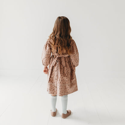 Back view 5-year-old girl in LARILI Cord Crush dress. Lavender animal print corduroy with lace collar and handmade details.