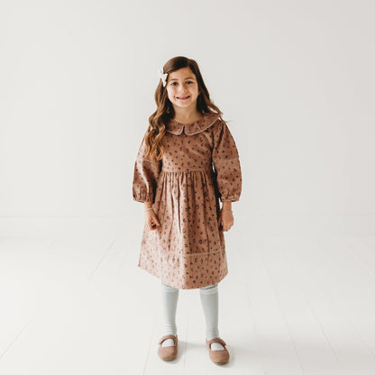 5-year-old girl in LARILI Cord Crush dress. Lavender animal print corduroy with lace collar and handmade details.