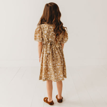 A 5-year-old model showing the back view of Embroidered fabric V shape Yoke Dress - LARILI