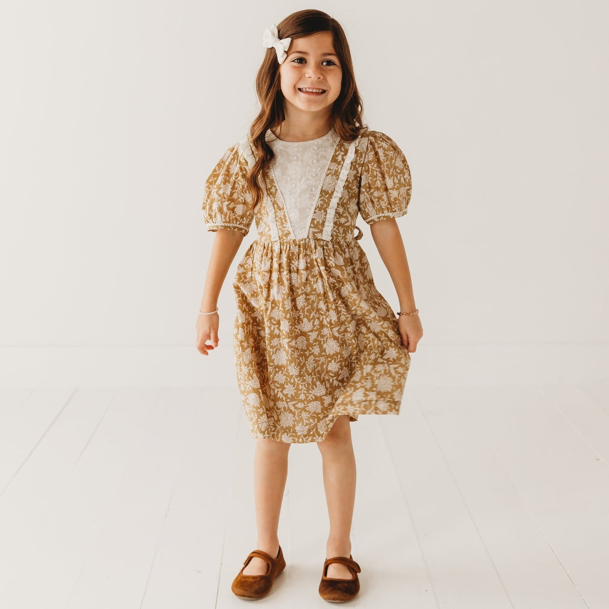 A 5-year-old model showing the Embroidered fabric V shape Yoke Dress - LARILI
