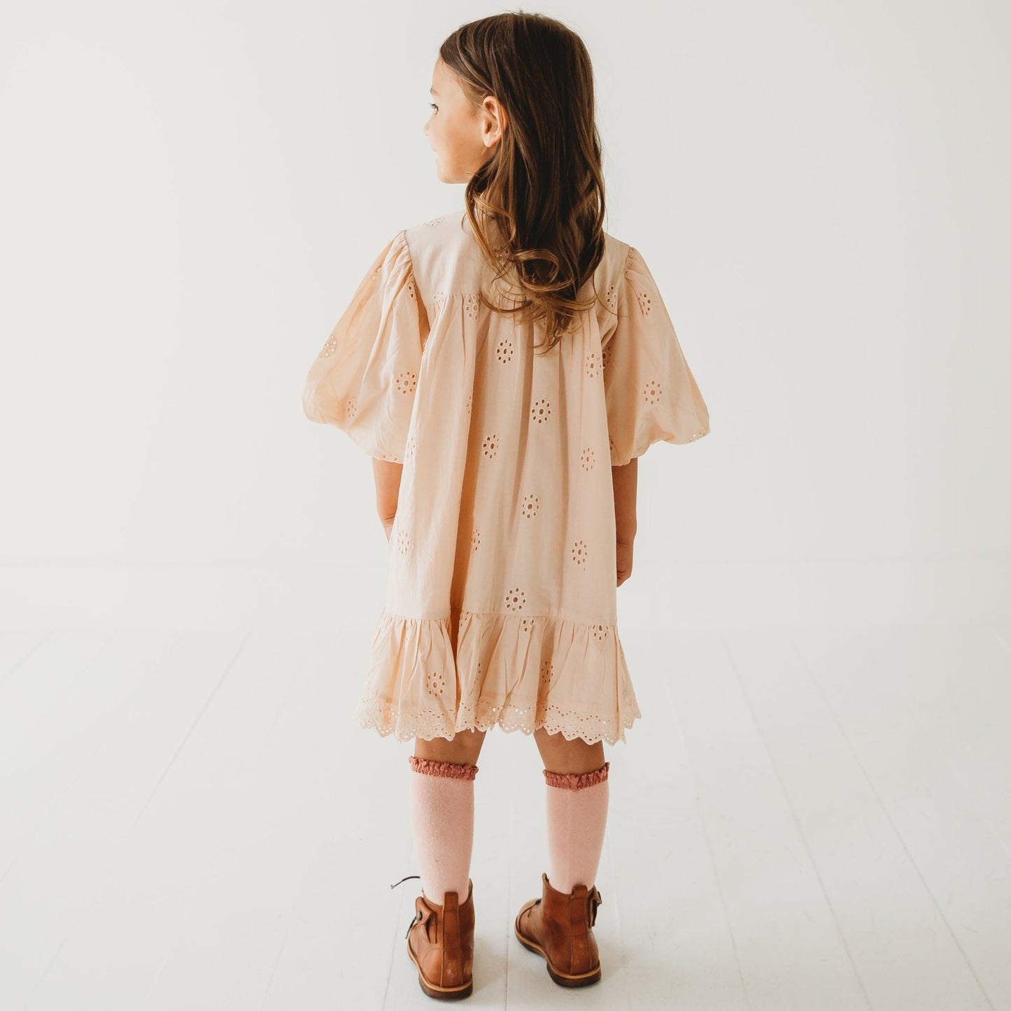 A 5-year-old model showing the back view of Embroidered Schiffli Dress - LARILI