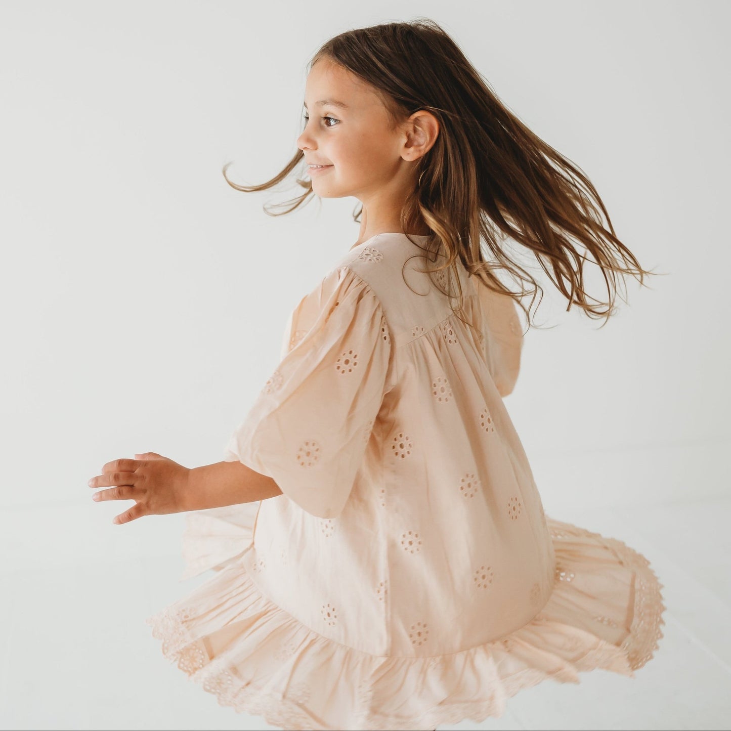 A 5-year-old model showing the Embroidered Schiffli Dress - LARILI
