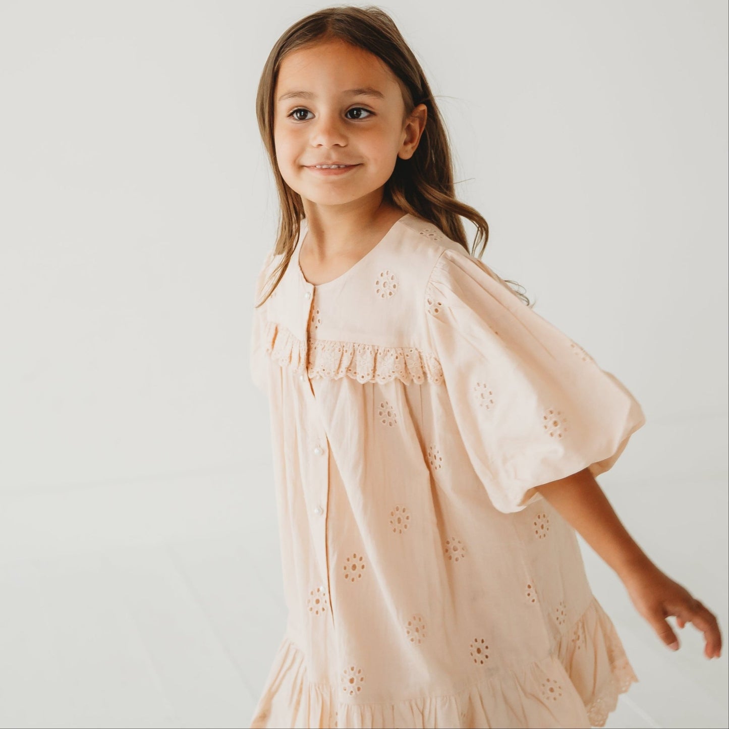 A 5-year-old model showing the close up of Embroidered Schiffli Dress - LARILI