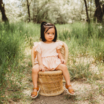 A 2-year-old model showing the Embroidered Schiffli Romper - LARILI