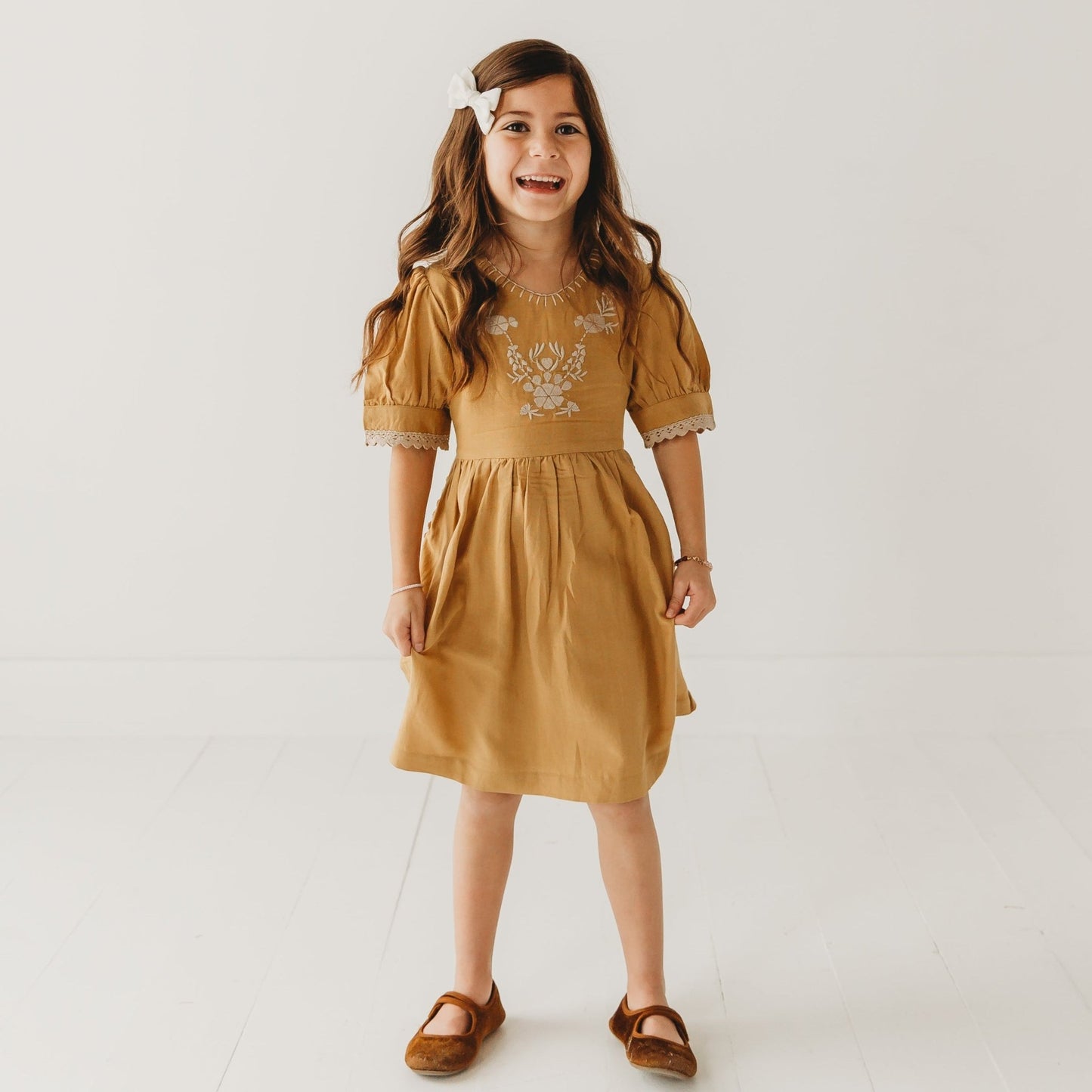 A 5-year-old model showing the Embroidered yoke with Puff Sleeves - LARILI
