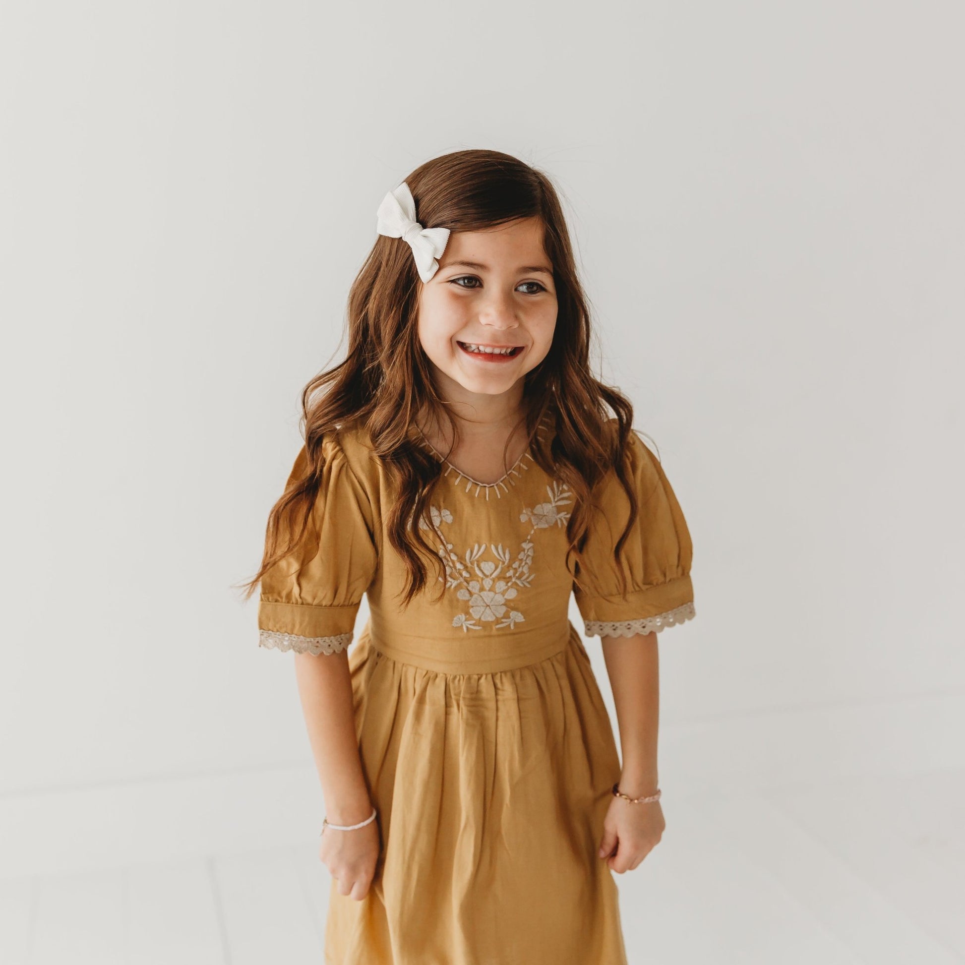 A 5-year-old model showing the close up of Embroidered yoke with Puff Sleeves - LARILI