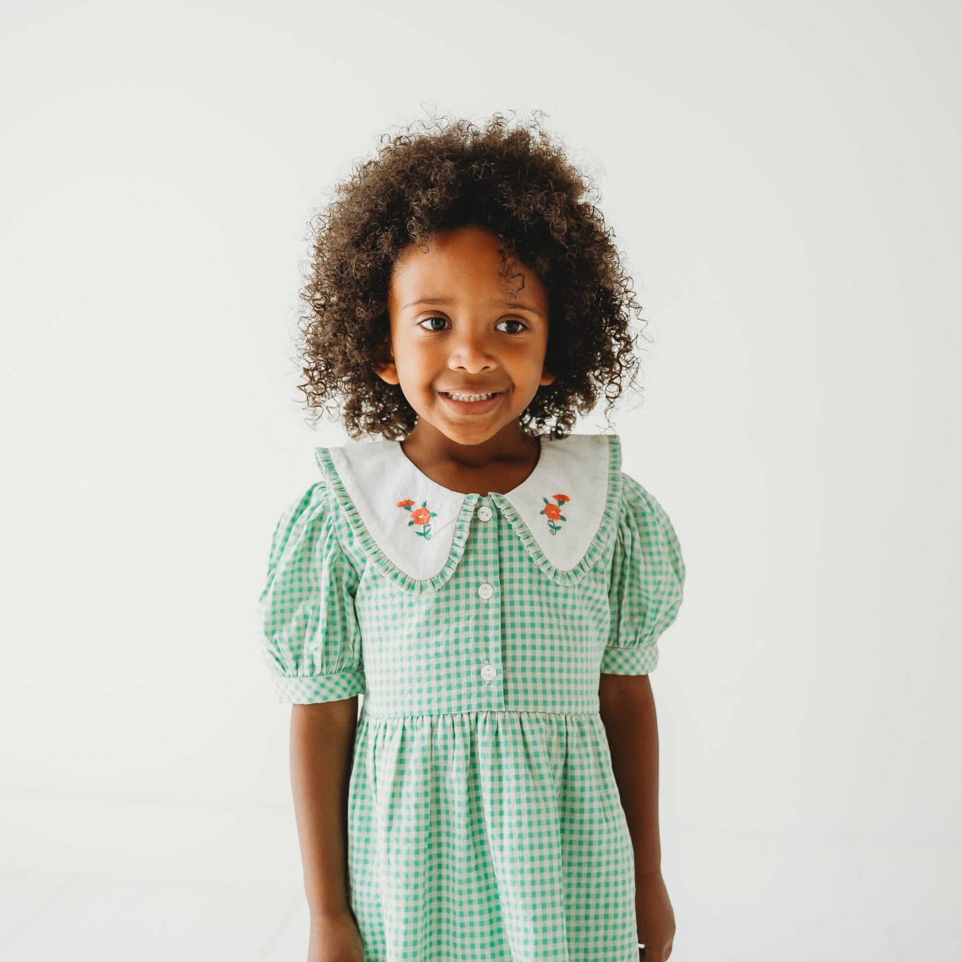 5 Year old Girl close up in Green Gingham Emb. Mia Dress - LARILI