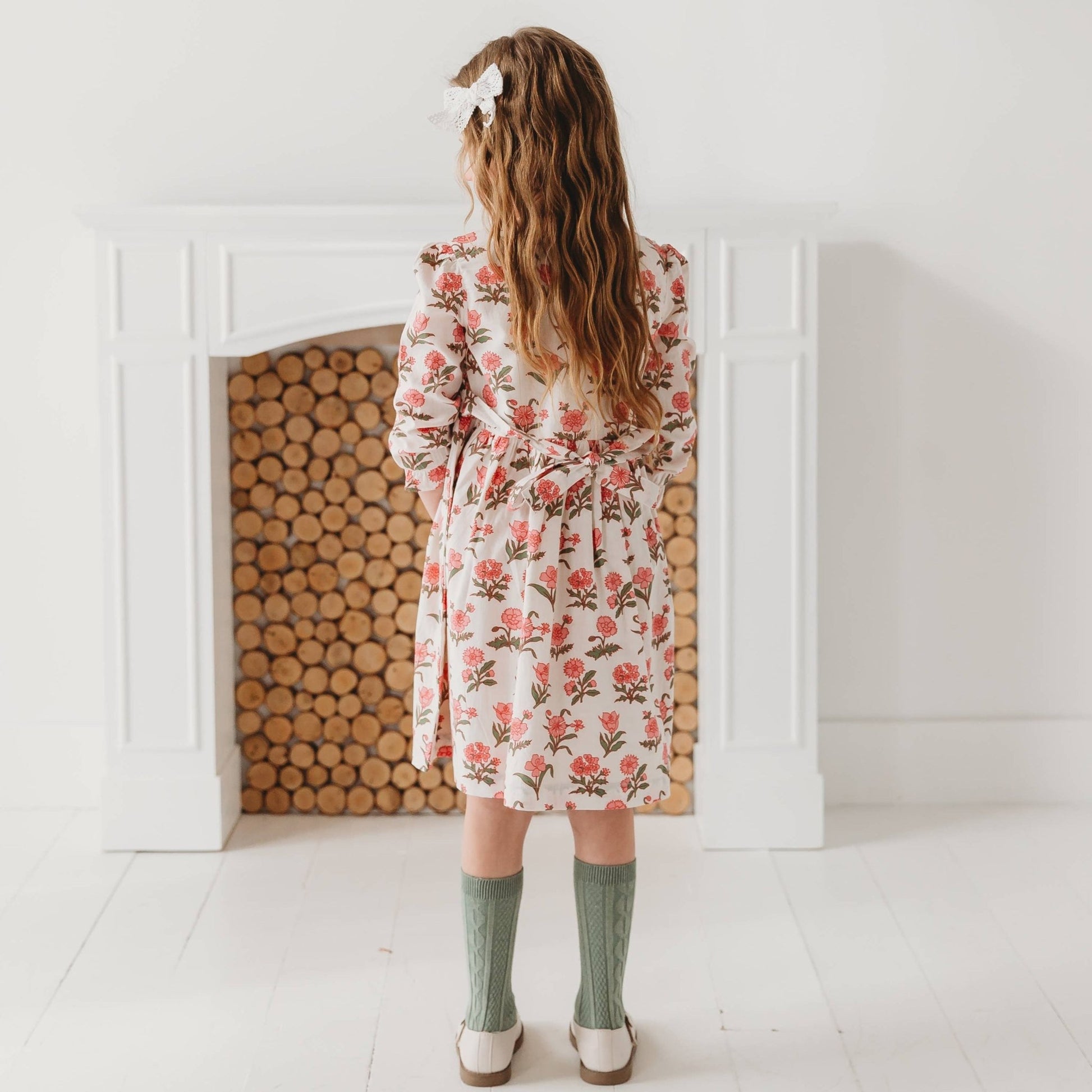 Little girl twirling in the Pink Block Print Flower dress, showing the full skirt and soft 100% cotton movement.