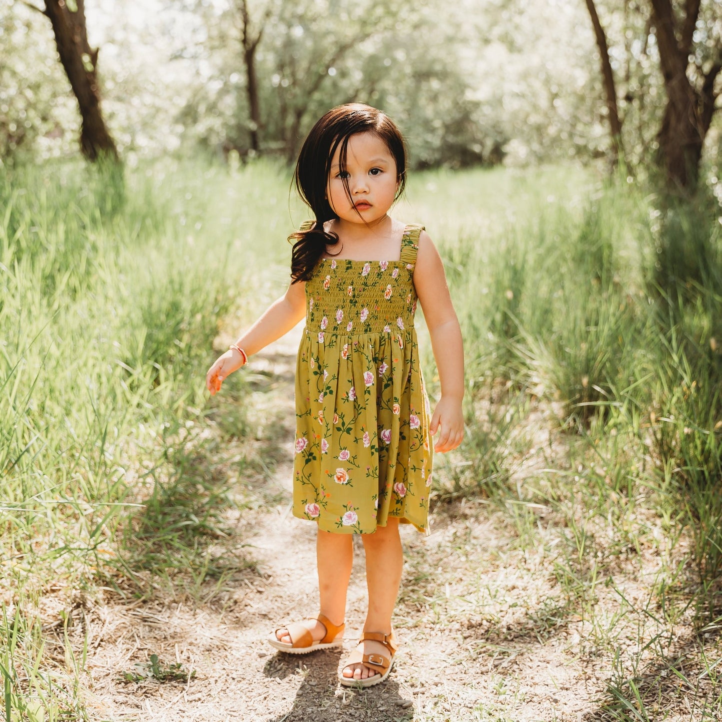 A 3-year-old model showing the Smocking High & Low Dress - LARILI