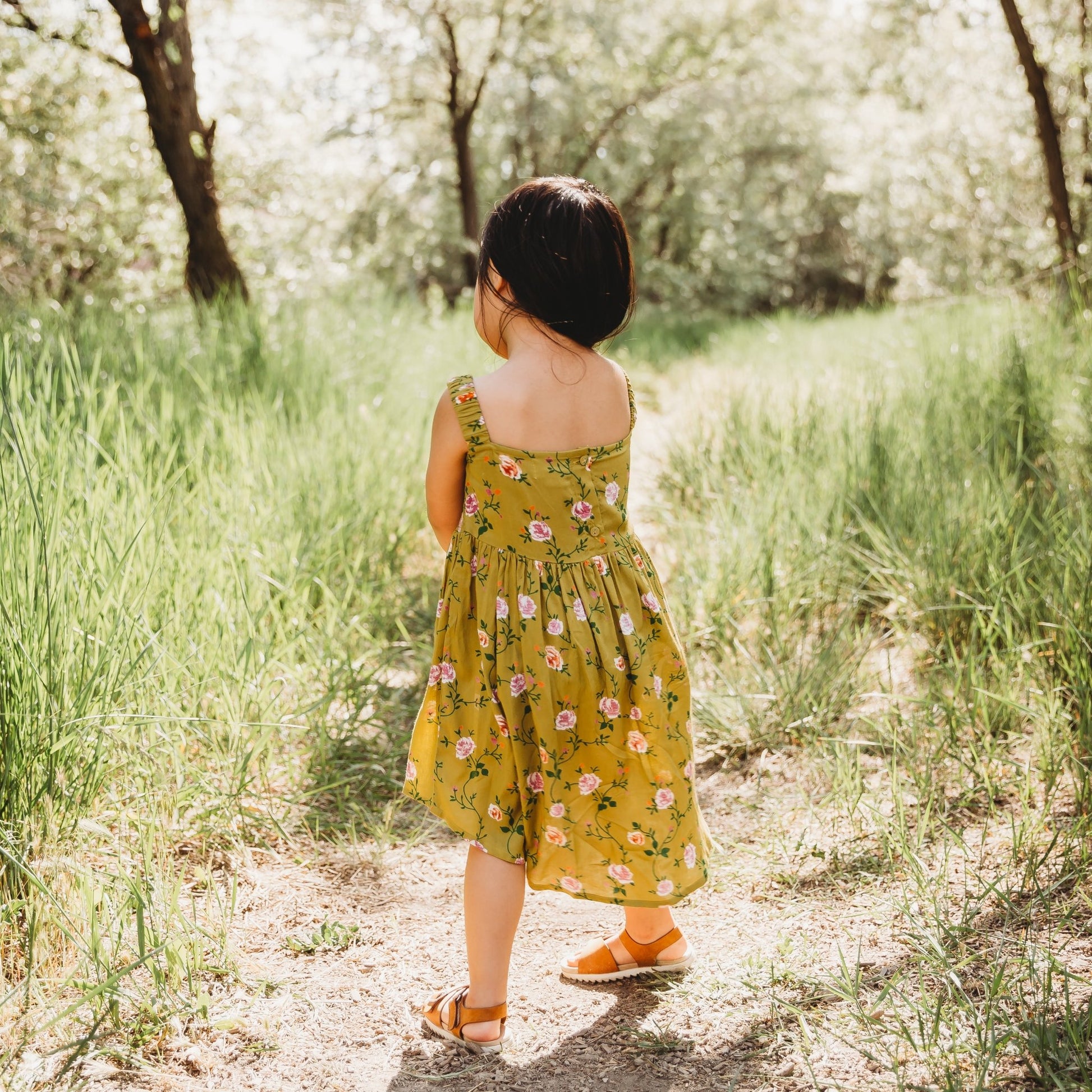 A 3-year-old model showing the back view of Smocking High & Low Dress - LARILI