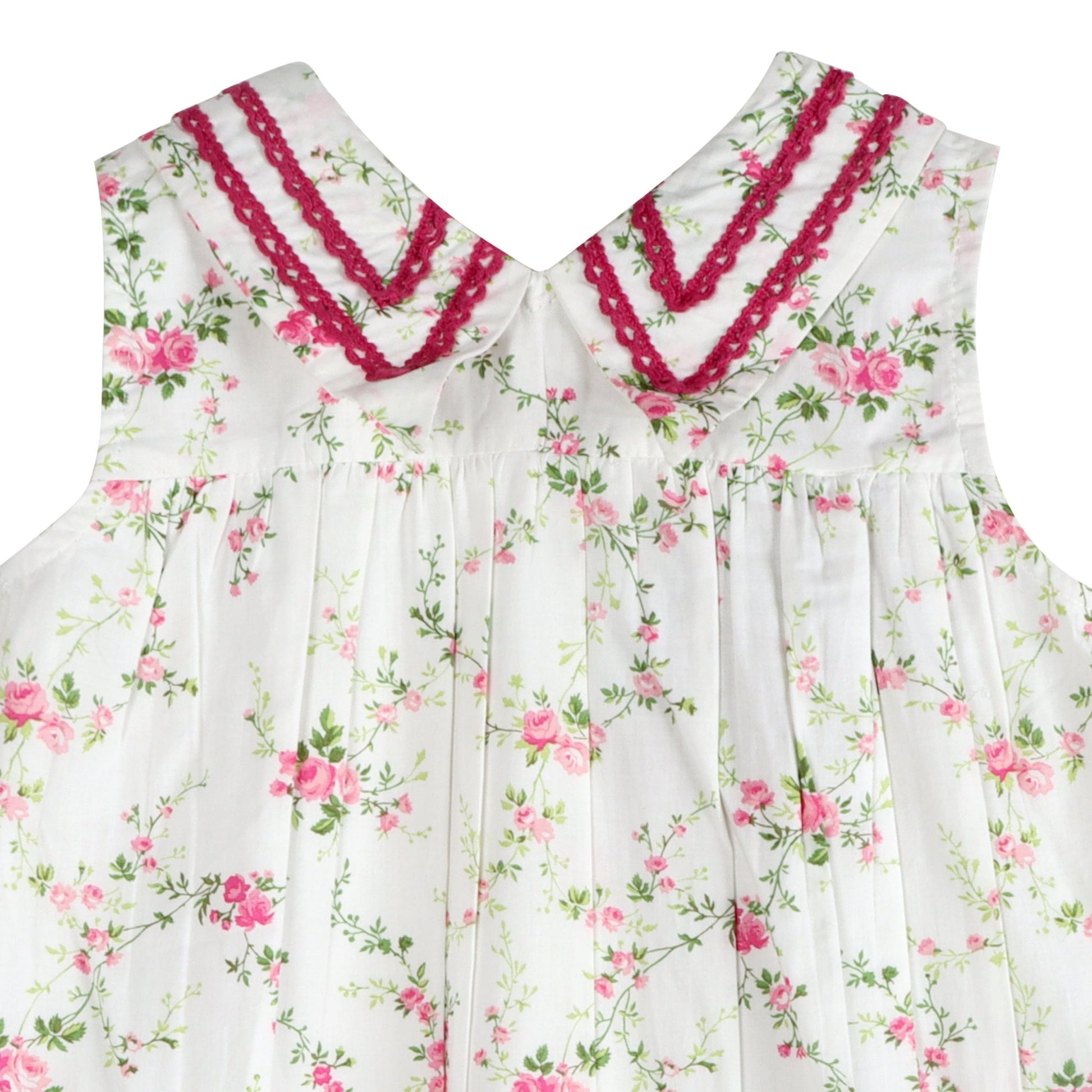 Close up of LARILI Victorian Rosebud dress. Pink floral cotton with lace V-neck and vintage button back.