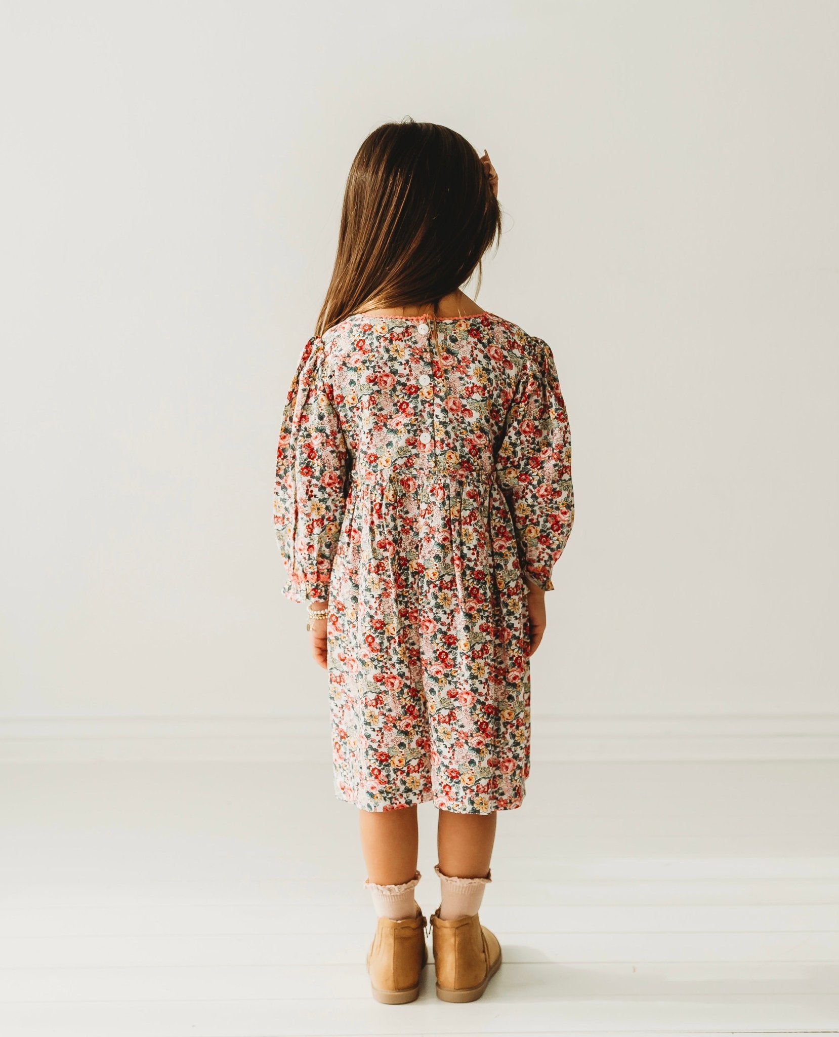 A 3-year-old model showing the back view of Long Sleeves Pink Bloom Overlap Girl's Cotton Dress - LARILI